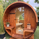 Wooden barrel-shaped structure with shelves and a door in an outdoor setting