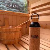 Corked bottle with black cap on a wooden surface, blurred natural background