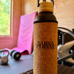 Cork-featured water bottle with 'SaunaPlunge' branding on a wooden surface.