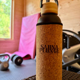 Cork-featured water bottle with 'SaunaPlunge' branding on a wooden surface.