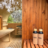 Two bottles with cork lids on a wooden  sauna.